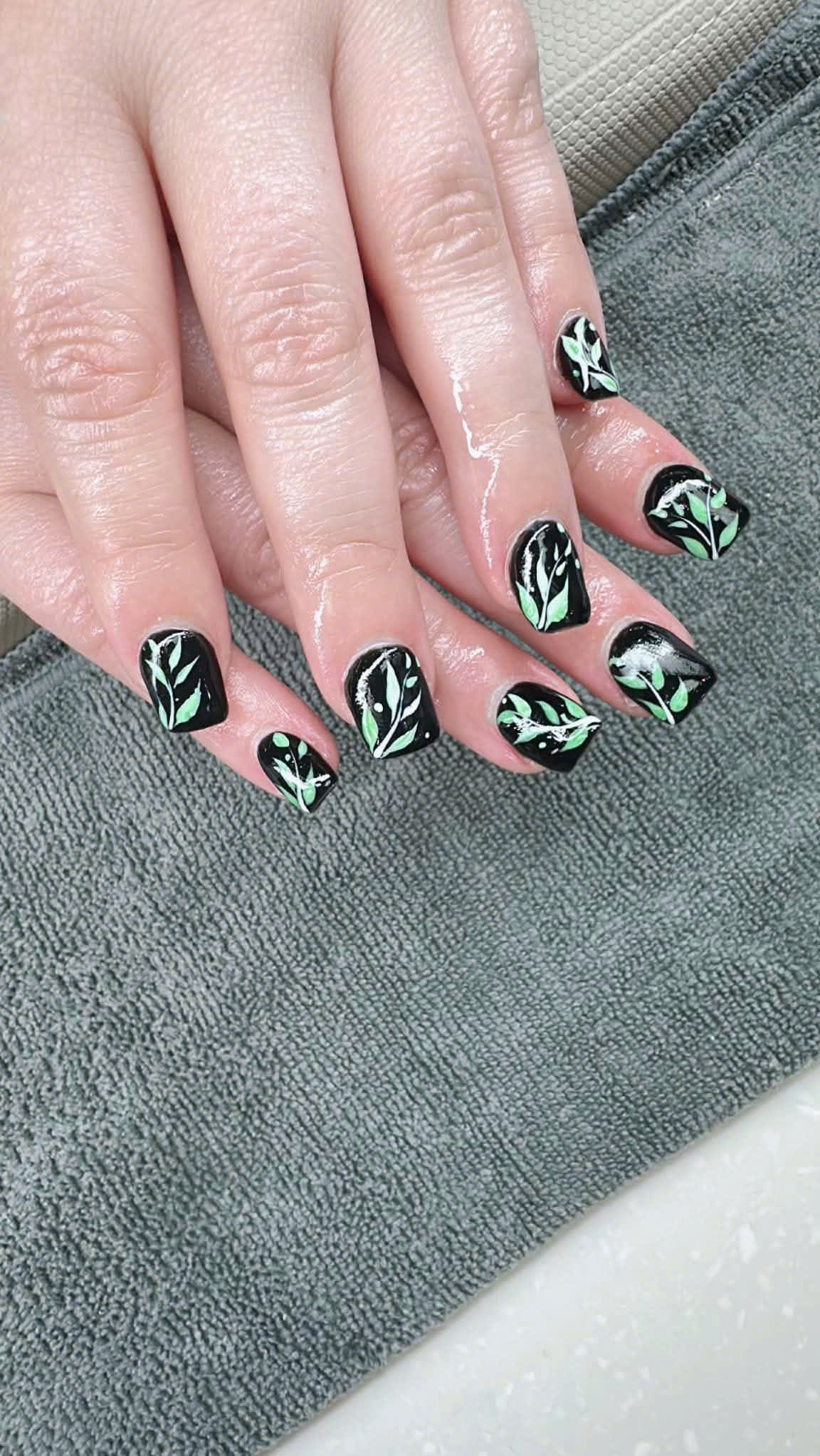 Leafy black manicure close-up