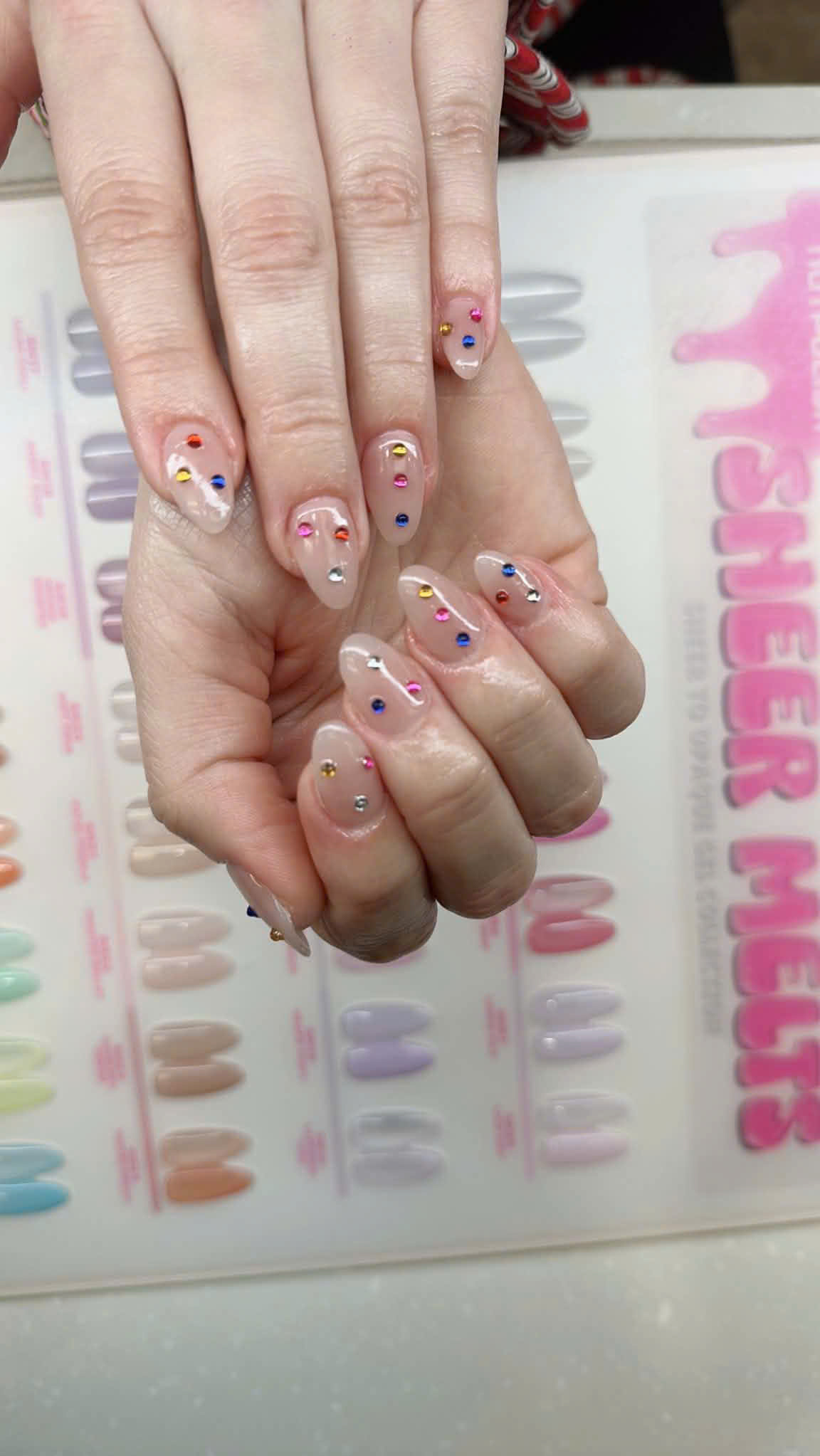 Sheer nude nails with colorful gems