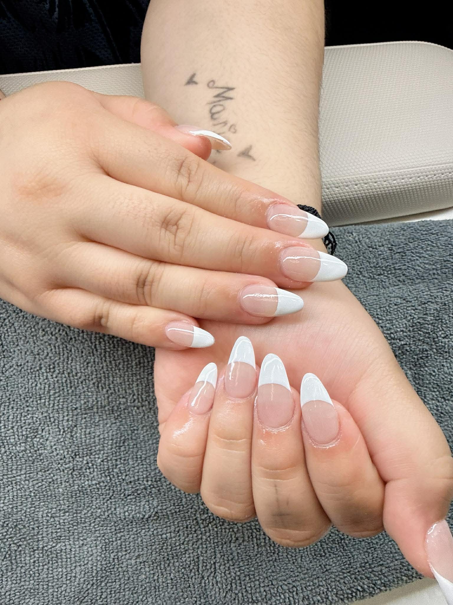 Close-up of white French tip nails