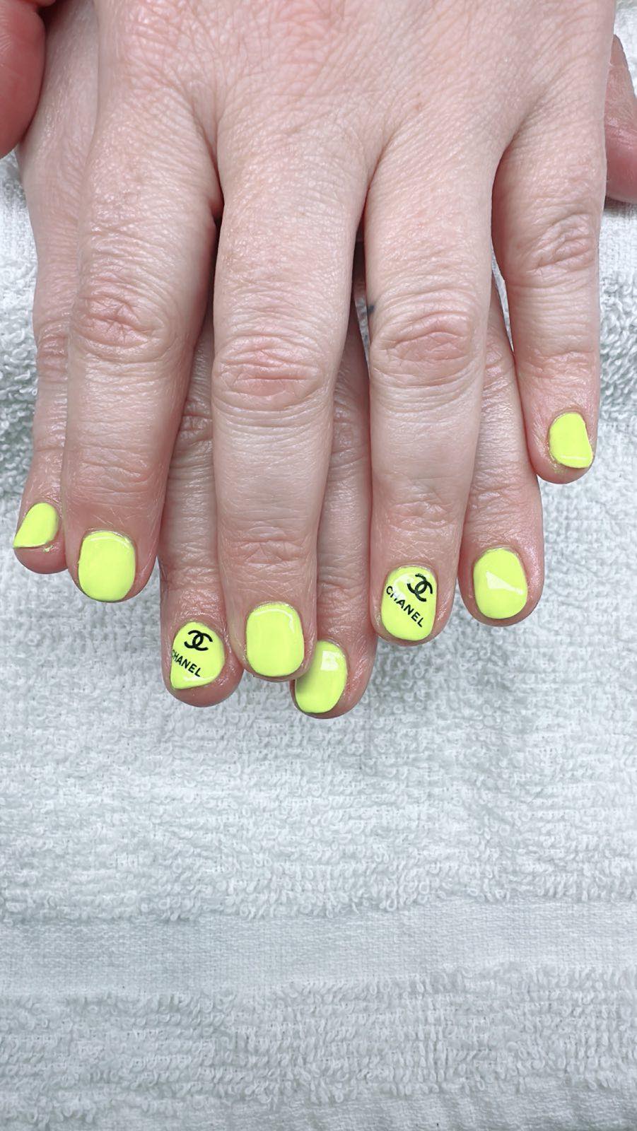 Bright yellow Chanel-inspired nails