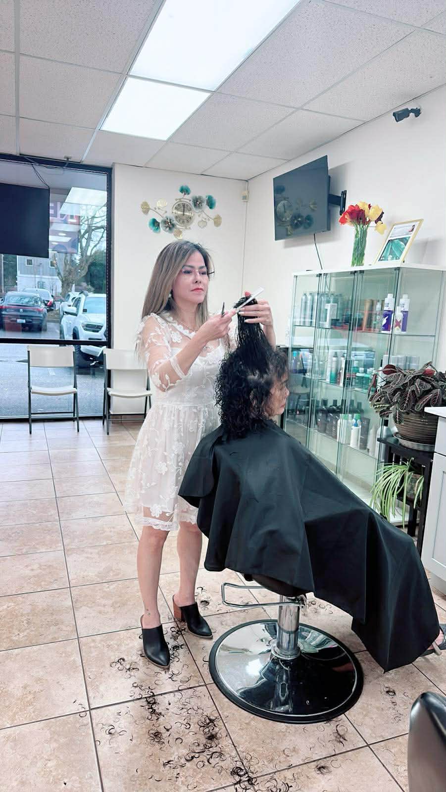 Stylist shaping a curly haircut